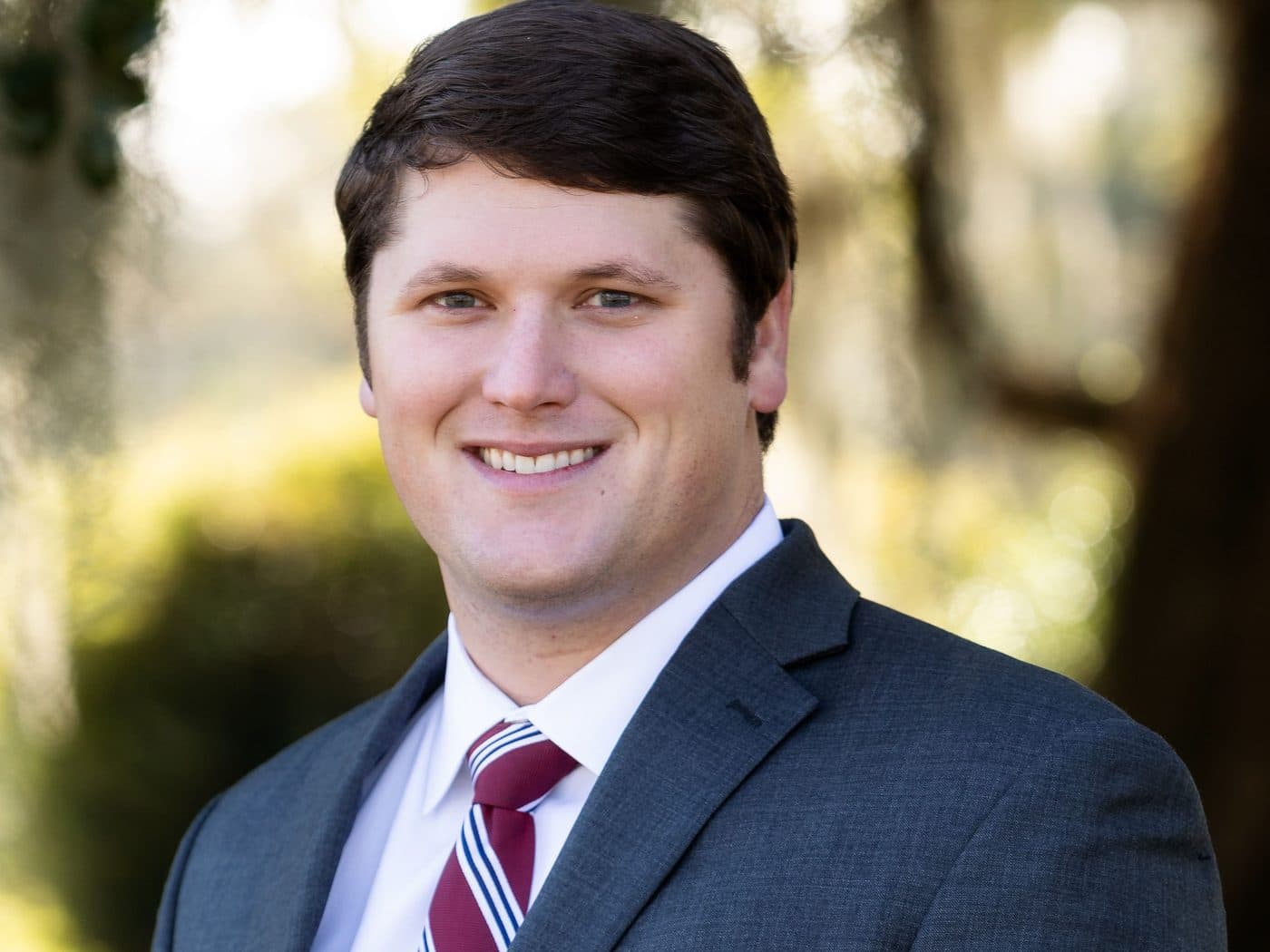 Attorney Rick Tadda of The Tadda Law Firm outdoors under live oaks
