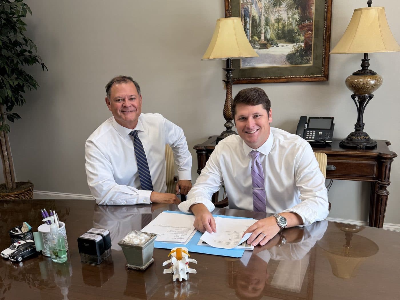 Erik Tadda and Rick Tadda at the conference table in the firm’s O'Neal Lane office