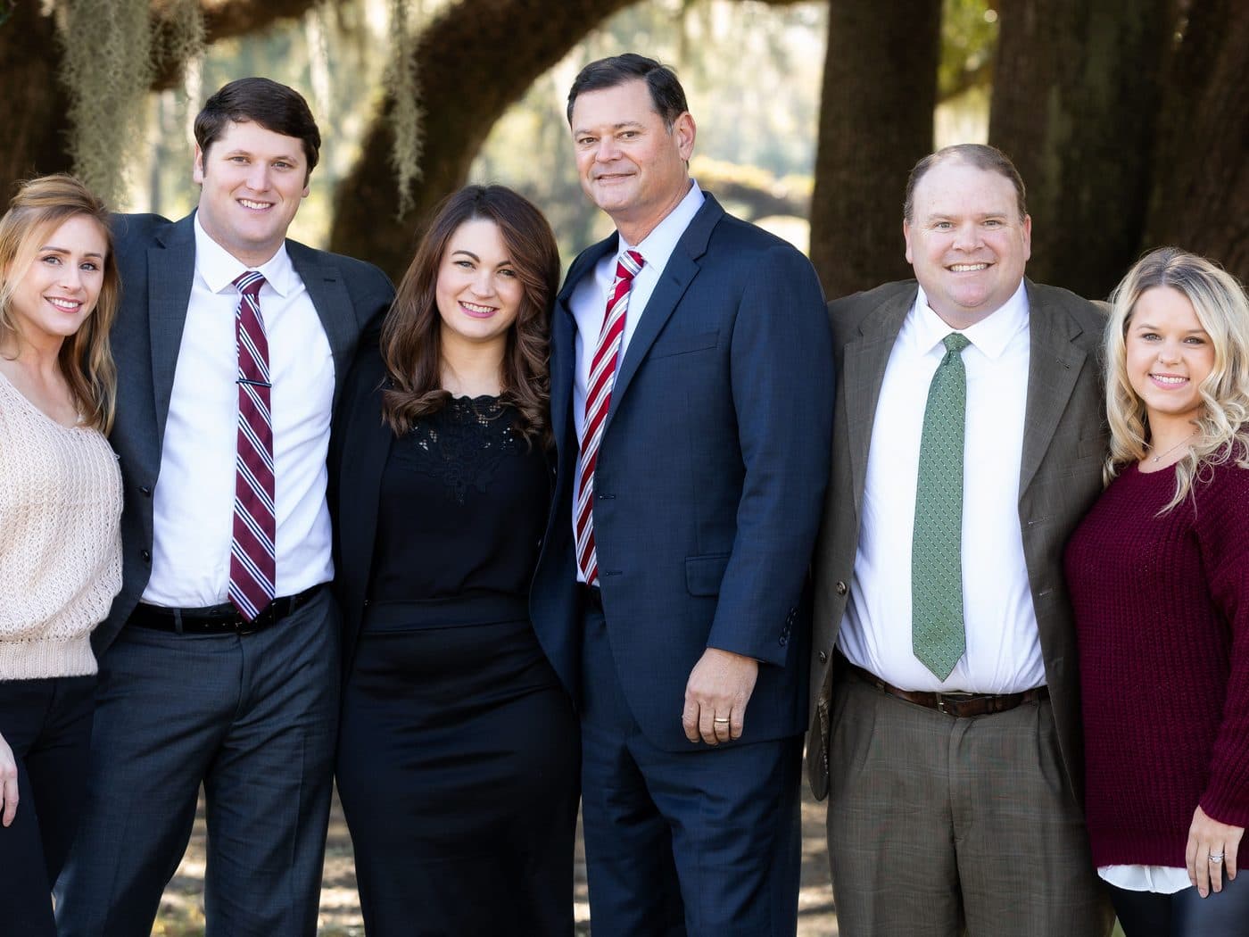The attorneys and staff of The Tadda Law Firm standing together outdoors