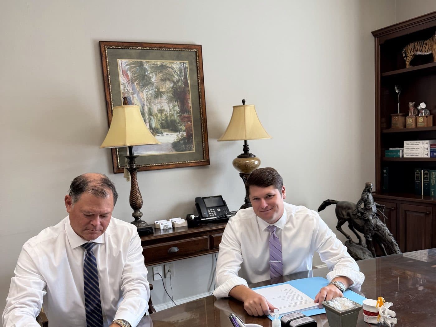 Erik Tadda and Rick Tadda seated at the conference table in the firm’s office
