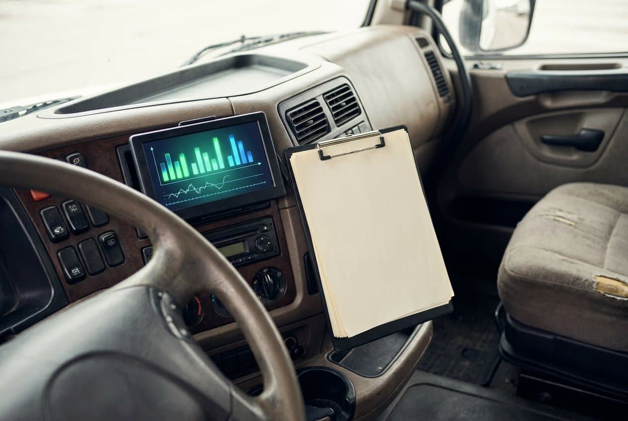 The dashboard and empty cab of a semi truck
